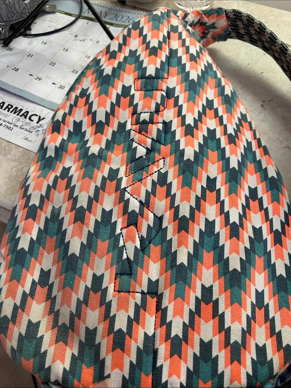 Kavu Chevron Sling Backpack in Coral, Teal & White With Wallet